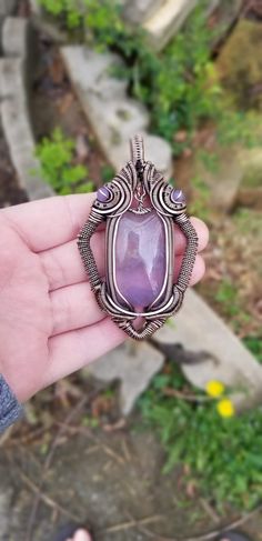 "**insurance included free of charge on all orders of $50 or more **being this is a collaboration piece with another artisan, it is not included in the sale. Price reflects the work and time each of us put into the piece. Total production time is 11.5 hours Vilin. \"airy, breezy, light\"! It features a beautiful Purple plume Fluorite (with moss-like inclusions) and is accented with 2 grape agate beads! The frame style was created using copper that was then oxidized and polished, and is partly El Artisan Amethyst Wire Wrapped Necklaces, Artisan Amethyst Wire Wrapped Jewelry, Mystical Wire Wrapped Jewelry For Gifts, Artistic Wire Wrapped Pendant Necklace, Unique Wire Wrapped Necklace, Unique Wire Wrapped Necklaces For Collectors, Grape Agate, Elven Jewelry, Wire Wrapped Crystal