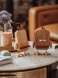 two wooden figurines sitting on top of a table