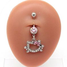 an image of a fake breast with a hello kitty charm on it