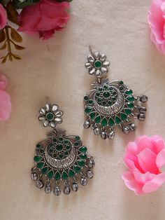 Discover elegance in our Green Ethnic Silver Earrings with Ghungroos. Meticulously handcrafted, these earrings seamlessly fuse traditional charm with contemporary style. The vibrant green and silver combination, coupled with intricate ghungroos, adds a unique flair to any outfit. Lightweight and versatile, they're perfect for both casual and formal occasions, allowing you to effortlessly embrace cultural sophistication. Elevate your style with these statement earrings that blend tradition and modernity with finesse. Available in two more stunning colour options.  In case of any queries, please feel free to contact us. Happy shopping! Green Aesthetic Earrings, Green Jhumka Earrings, Silver Chandelier Earrings With Oxidized Finish For Festive Occasions, Oxidized Finish Earrings For Diwali Celebration, Fusion Style Chandbali Jewelry With Oxidized Finish, Festive Silver Chandelier Earrings With Oxidized Finish, Festive Dual-tone Fusion Danglers, Festive Fusion Dual-tone Danglers, Festive Oxidized Drop Earrings