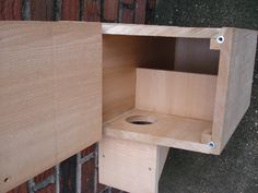 a wooden shelf with a hole in it