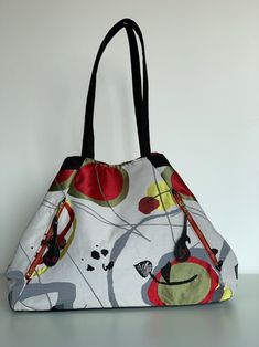 "Colorful Splashes Large Expandable Tote Bag \"The Essence of Abstract.\" This colorful tote with black suede handles and base. It has 2 zippered pockets on the front and 2 pockets inside the lining. Snaps on the side make the bag smaller and there is a magnetic closure. 20\"x5\"x18\" largest capacity 14\"x5\"x18\" when cinched" Multicolor Rectangular Bucket Bag For On-the-go, Multicolor Rectangular Modern Bucket Bag, Modern Multicolor Rectangular Bucket Bag, Multicolor Bags With Zipper Pocket For On-the-go, Modern Multicolor Bucket Shoulder Bag, Multicolor On-the-go Bucket Bag With Adjustable Strap, Multicolor Pouch Bucket Bag With Detachable Handle, Multicolor Canvas Hobo Bag With Adjustable Strap, Multicolor Reversible Bag With Double Handle