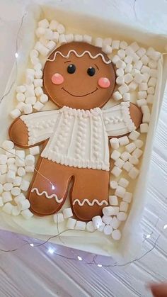 a gingerbread man is in the middle of marshmallows and icing