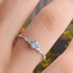 a woman's hand with a diamond ring on it