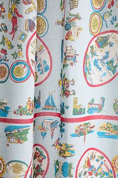 the curtain is decorated with images of different cities and towns in blue, red, green, yellow and white