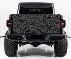 the back end of a jeep with an interesting design on it