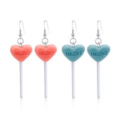 four candy lollipops with the words in love written on them are shown