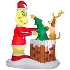 a large inflatable christmas decoration with a dog and santa clause decorating the tree