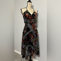 This Soft Black Floral Velvet Dress Has A Fit And Flare Style With Crossover Bodice. Dress It Up For A Night On The Town Or Add A Hat And Some Flats For A Boho Chic Vibe. Fully Lined With Back Zipper And Adjustable Bodice Straps. Black A-line Bohemian Dress, Black Bohemian A-line Dress, Fitted Black Printed Maxi Dress, Flowy Black Floral Dress For Beach, Black Flowy Floral Maxi Dress, Black Floral Midi Dress For The Beach, Black Floral Midi Dress For Beach, Bohemian Sleeveless Midi Dress For Night Out, Black Sleeveless Rayon Maxi Dress