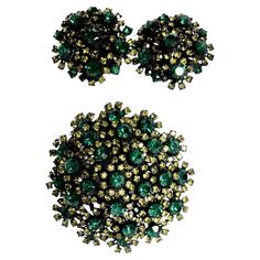 Vendome semi-parure of dome-shaped brooch and clip-on earrings composed of large round green crystals, each surrounded by small lime-colored crystals in a floral manner, and each with a filigree frame of black metal. The earrings have adjustable screwbacks, which makes them more comfortable. Vendome (1940s-'70s) was the high-end division of the more popular priced Coro company and was known for the quality crystals and craftsmanship of their designs. This set has an unusual color palette with great sparkle and sophistication. Brooch: 2" diameter, 1" depth Earrings: 1.25" diameter Filigree Frame, Crystal Brooch, Green Crystals, Color Crystal, Black Metal, Lima, Division, Clip On Earrings