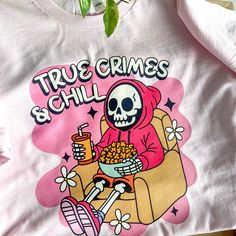 👻🎃👻 Ghouls (girls) just wanna have fun and wear cute spooky season tees🥰 #truecrimejunkie #truecrimefan #spookyseason #halloweenvibes #spookygirl #spookygirlsdoitbetter #spookyvibes #stayspooky #halloween365 #halloweenallyear #truecrimeandchill #truecrimeaddict #truecrimeobsessed #cozy #cozyvibes #thisishalloween #smallbusiness #smallbiz Halloween Pink T-shirt With Screen Print, Pink Halloween T-shirt With Screen Print, Novelty Crew Neck Top With Screen Print, Novelty Letter Print Tops For Streetwear, Pop Culture Screen Print Tops With Relaxed Fit, Pop Culture Cotton Top With Graphic Print, Trendy Cotton T-shirt With Skull Print, Trendy Cotton Skull Print Tops, Pop Culture Tops With Funny Print And Relaxed Fit