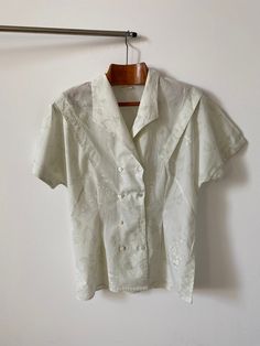 "Vintage double breasted cotton blouse for women Size 38 | Short Sleeve Blouse with delicate floral print. The greenish off white blouse has a fitted waist and a lovely sleeve pleated detail. Just a beautiful romantic summer blouse, great with jeans, shorts, skirts too. Composition: probably cotton. no composition tag attached.  Size: 38 Condition: excellent Measurements*: Armpit to armpit: 46 cm | 18.1\" Length: 68 cm | 26.8\" Waist: 42 cm | 16.5\" Hips: 50 cm | 19.7\" Shoulders: 40 cm | 15.7\" Classic Formal Tops With Floral Print, Cotton Top For Wedding In Spring, Spring Wedding Button-up Blouse, Classic Short Sleeve Tops For Wedding, Classic Floral Print Tops For Daywear, Formal Cream Cotton Top, Cream Cotton Top For Formal Occasions, Cream Short Sleeve Top For Wedding, Classic Summer Wedding Top