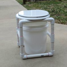 a white toilet sitting on top of a sidewalk