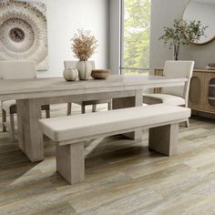 a dining room table with two benches next to it and vases on the side