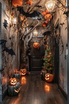 a hallway decorated for halloween with pumpkins and bats on the wall, lights hanging from the ceiling