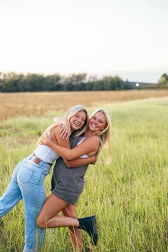 two women hugging each other in a field