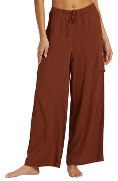 A lightweight crinkle fabric adds airy ease to slouchy wide-leg cargo pants topped with a comfortable elastic-drawstring waist. 27 1/2" inseam; 26" leg opening; 13" front rise; 14" back rise (size Medium) Elastic/drawstring waist Front slant pockets; cargo flap-patch pockets 100% viscose Machine wash, tumble dry Imported Relaxed Fit Parachute Pants With Elastic Waistband For Beach, Solid Wide Leg Beach Pants With Drawstring, Spring Vacation Relaxed Fit Cargo Pants, Vacation Wide-leg Cargo Pants With Pockets, Relaxed Fit Cargo Pants For Spring Vacation, Wide-leg Cargo Pants With Pockets For Vacation, Summer Vacation Wide-leg Cargo Pants, Summer Cargo Pants With Elastic Waistband For Vacation, Casual Relaxed Fit Cargo Pants For Vacation