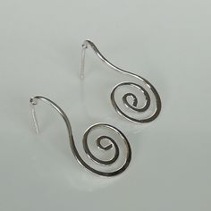 IMPORTANT **Please go through all the pictures i have posted for a listing with a ruler, on a model, on my hand, to get an exact idea of the actual size of the item. Sterling silver spiral dangle earring. Dimension: 15 x 29 mm Weight: 2.4 gm Price listed is for ONE PAIR. These earrings are made of 925 hypoallergenic sterling silver. All my pieces are sent in a gift box. I can include a personal message from you if needed. You are welcome to contact me at... bhavnakwintra1956@gmail.com More Silve Handmade Silver Swirl Earrings, Swirl Earrings For Pierced Ears, Modern Twist Silver Spiral Earrings, Swirl-shaped Pierced Earrings For Gift, Modern Swirl Earrings For Gift, Handmade Sterling Silver Earrings With A Modern Twist, Swirl-shaped Earrings With Ear Wire, Sterling Silver Spiral Wrap Earring, Spiral Sterling Silver Single Wrap Earring