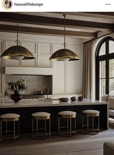 a large kitchen with white cabinets and black counter tops is featured in the article housefuldesign