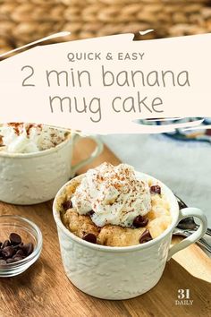 two mini banana mug cakes with whipped cream and chocolate chips in them on a wooden table