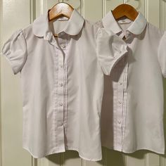 Two Tops, Girls Size 6/7, White Button Down, New Without Tags, Never Been Wash Or Worn. In Excellent New Condition. 65% Polyester And 35% Cotton Cute Fitted Shirt With Buttons, Cute Fitted Sets With Buttons, School Uniform Sets With Long Sleeves, Classic Fitted Tops For School, Short Sleeve Cotton Top For School Uniform, Classic Short Sleeve School Tops, Cotton Short Sleeve School Uniform Top, Fitted Collared School Uniform Tops, Classic Short Sleeve Tops For School