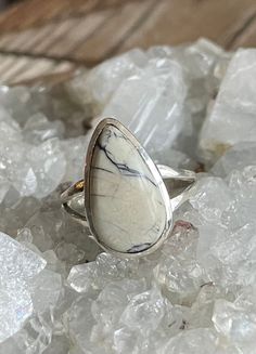 "White Buffalo Turquoise Sterling Silver Ring US Size 8 White Buffalo Turquoise is only found in Nevada White Buffalo Turquoise stone 17x10mm Top of ring is 3/4\" by 1/2\" 4g Sterling Silver, stamped 925 White Buffalo--also known as White Buffalo Turquoise--is a gemstone that is mined in Nevada USA. It was presumed to be Turquoise due t to it being found in Turquoise mines however; its classification is magnesite and alumite. It has been popularized as White Turquoise. The stones are all natural Adjustable Turquoise Ring With Natural Stones For Anniversary, Silver Howlite Jewelry With Natural Stones, Healing Turquoise Ring With Natural Stones, Adjustable White Rings With Stones, White Buffalo Turquoise, Nevada Usa, Gem Mining, Black Gems, Natural Stone Jewelry