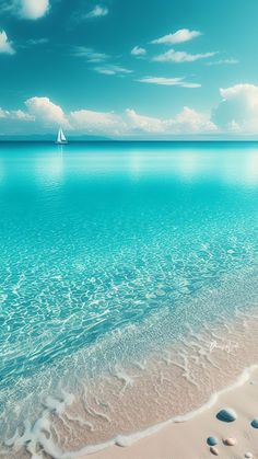 the beach is clear and blue with some white sand on it, as well as a sailboat in the distance