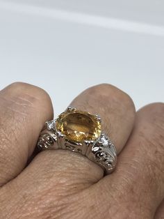 Unusual cut of citrine surrounded by white sapphires Sterling Filigree finished Setting Handmade Size 6 Can be resized, my jeweler charges a $10 fee All rings are shipped in a nice gift box. Check out our over a THOUSAND great reviews Engraving is $4 per letter and is not always perfect depending on the piece. It can take a few days if the jeweler is busy. This is payable to Paypal Judithsltd@gmail.com Luxury Yellow Sapphire Jewelry With Accent Stones, Luxury Yellow Sapphire Ring For Anniversary, Luxury Yellow Sapphire Anniversary Ring, Luxury Yellow Gemstones For Anniversary, Elegant Yellow Sapphire Ring With Prong Setting, Oval Yellow Sapphire Jewelry With Center Stone, Round Yellow Sapphire Ring With Accent Stones, Formal Yellow Topaz Ring With Diamond Accents, Elegant Oval Yellow Sapphire Ring