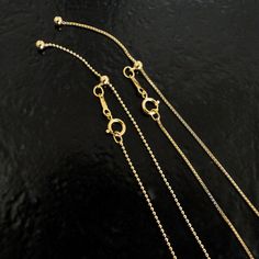 "This adjustable 'slide' chain is made of 14/20 Gold Filled - the best that you can get next to solid gold. Choose a box chain or a ball chain. They are flexible, 'slinky', shiny, and versatile - perfect to wear alone at different lengths, including choker length, or add your favorite charms. Details: 1) 14/20 gold filled box or ball chain - approximately 1mm in width. 2) Overall length is adjustable from 1\" to 22\". 3) 14/20 gold filled 5mm spring clasp, 8mm jewelry tag stamped with the 14/20 Adjustable Box Chain Necklace With Round Shape, Adjustable Round Box Chain Necklace, Classic Ball Chain Necklace As Gift, Adjustable Gold Ball Chain Jewelry, Adjustable Gold Box Chain Necklace, Adjustable Yellow Gold Box Chain Necklace, Adjustable Gold Ball Chain Necklace, Adjustable Ball Chain Necklace As Gift, Adjustable Ball Chain Necklace For Gift