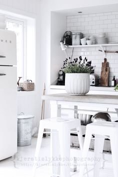 two pictures of the same kitchen and dining room in different rooms, one is white