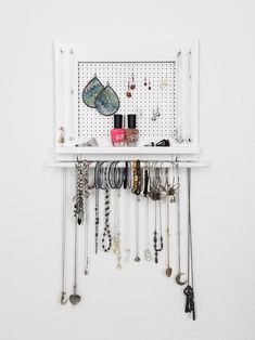 a white shelf filled with lots of jewelry