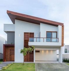 a white house with brown trim and wooden accents