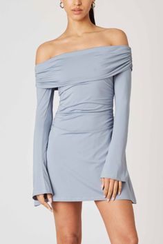 Ava Dress Color: Slate Blue Stretchy, fitted mini dress. Off-the-shoulder folded neckline Long sleeves Side ruching Pull-on style Poly/Spandex Blend | Model is wearing a Small