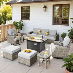 an outdoor patio with furniture and potted plants