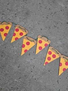 four slices of pizza are lined up on the ground