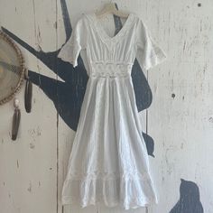 This 1970s Mexican Wedding Dress Is Just Such A Pure Delight And The Optimum Of Femininity! Chris White Cotton With Rose Of Pinto And Scallop Lace, A Front And Back V-Neck, A Gathered Waist Skirt With Lace Panels And Tiered Lace Sections. The Upper Sleeves With Beautiful Crocheted Lace Are Gathered With Flouncy Lace. The Center Back Of Dress Has A Lapped Metal, Zipper, And A Hook And Eye Closure. This This Is A Beautiful Bohemian Retro Dress That Can Be Worn So Many Ways With Western Boots Comba Combat Boots Dress, Mexican Wedding Dress, Boots Combat, Skirt With Lace, Crocheted Lace, Mexican Wedding, Scalloped Lace, Lace Panelled, Metal Zipper