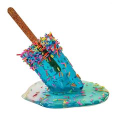 a blue cup with sprinkles and a straw sticking out of it