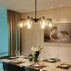 a dining room table is set with place settings and glassware for four people to eat