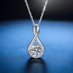 Indulge in timeless elegance with our 18K Gold Plated Solitaire Round Moissanite Infinity Pendant Necklace. This exquisite piece features a stunning 8mm, 2-carat Moissanite stone, renowned for its brilliant sparkle and clarity. Set in a sophisticated infinity design and plated in luxurious 18K gold, this necklace is the epitome of refined beauty. ✨ Key Features: Radiant Moissanite: The centerpiece is an 8mm round Moissanite gemstone, offering the brilliance of a D color diamond at a fraction of Elegant Silver Solitaire Teardrop Pendant Necklace, Silver Teardrop Solitaire Necklace, Elegant Teardrop Solitaire Necklace For Anniversary, Elegant Teardrop Pendant Solitaire Necklace For Anniversary, Teardrop Brilliant Cut Bridal Necklace As Gift, Brilliant Cut Teardrop Bridal Necklace Gift, Teardrop Brilliant Cut Bridal Necklace For Gift, Elegant Teardrop Necklace For Anniversary, Silver Drop Solitaire Necklace For Formal Occasions