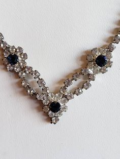 This is a vintage silver tone metal and clear and blue rhinestone necklace. The length is 17 inches. Don't forget to stop in at my other Etsy shop... http://www.etsy.com/shop/xtdesigns. Follow me on Twitter at... MyYiayiaHadThat@MyYiayiaHadThat. If you have a wish list or are looking for something specific, please ask. I may have exactly what you are looking for. As always please convo me with any questions or concerns regarding this item or with any international shipping questions. Unfortunate Vintage Blue Necklace For Evening, Vintage Blue Crystal Necklaces, Vintage Blue Rhinestone Jewelry, Blue Vintage Crystal Necklaces, 1950s Bride, Something Old, Blue Rhinestones, Rhinestone Necklace, Bride Bridal