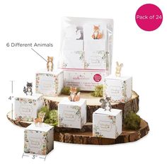 the package contains six different animals and is on top of a tree stump with moss