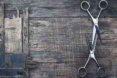 a pair of scissors sitting on top of a wooden table