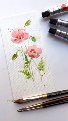 some watercolors are sitting on top of a table