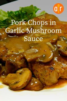 pork chops in garlic mushroom sauce on a plate with lettuce and mushrooms