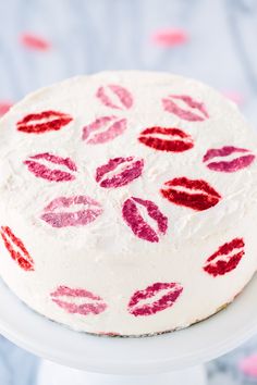 a white cake with red and pink lipstick on it