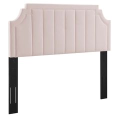 an upholstered headboard with black legs and a pink velvet finish on the frame