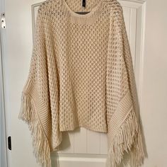 Elan Cream Fringe Poncho, Never Worn. Spring Fringe Poncho One Size, Beige Batwing Sleeve Poncho For Fall, Long Sleeve Fringe Poncho, Chic Beige Poncho For Spring, Oversized Shawl Poncho For Spring, Cozy Spring Poncho With Batwing Sleeves, Oversized Fringe Cape Poncho, Beige Fringe Poncho For Fall, Cozy Batwing Sleeve Poncho For Spring