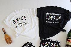 the bride and groom shirts are laid out next to bottles of champagne, wine bottle, and t - shirts