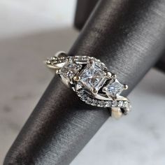 A Womens Vintage Estate 14k White Gold Diamond Ring. The Ring Weighs 6.7g And Is A Size 5.75. The Width Of The Ring Is About 3/8". The Carat Weight Of The Three Center Diamonds Are About 0.91cts, Accented With 24 Side Diamonds. Ring Is Marked "14k" . Any Questions Please Ask Prior To Purchasing. Be Sure To Check Out Some Of My Other Great Items Up For Sale. Thank You Fine Jewelry Princess Cut Cluster Wedding Ring, Heirloom Jewelry With Diamond Accents, Princess Cut, White Gold Jewelry With Vs Clarity And Princess Cut, Heirloom Princess Cut Jewelry With Diamond Accents, Princess Cut 14k White Gold Jewelry, Princess Cut White Gold Jewelry With Vs Clarity, Princess Cut Vs Clarity White Gold Jewelry, 14k Gold Three Stone Diamond Ring, Three Stone Diamond Ring In 14k Silver Gold