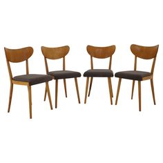 three wooden chairs with black upholstered seats